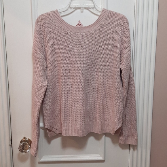 Pink knit sweater with tie in the back
